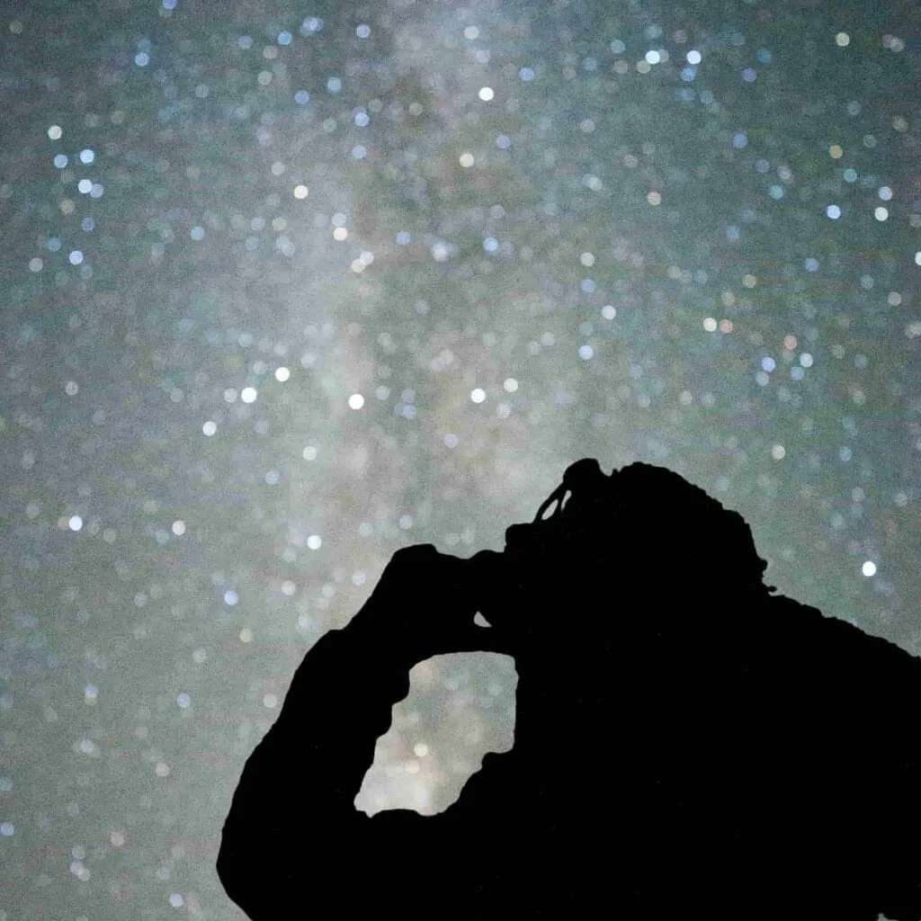 Picture the obstacle, not only the win: a person's silhouette against a night sky full of stars