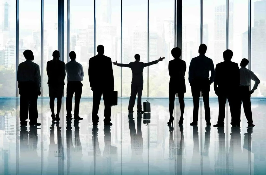 What kind of people are visionaries: one person with arms flung wide among a quiet row of office silhouettes