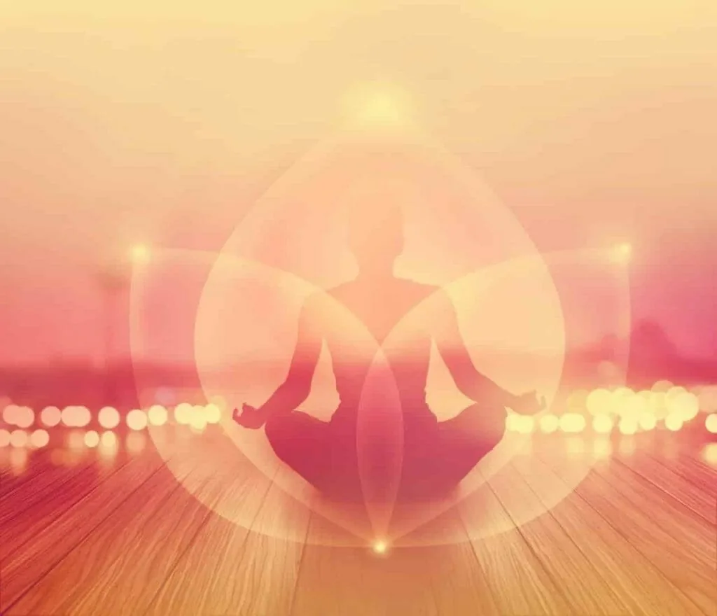 Law of correspondence: a glowing silhouette meditating inside a soft circle of light on a wooden floor