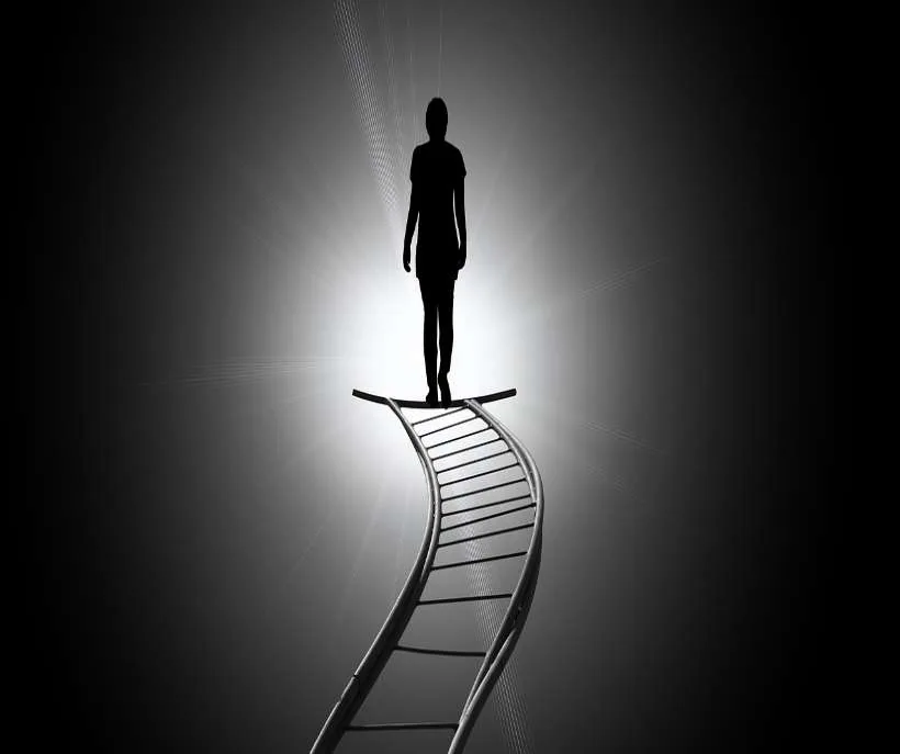 4321 meaning for your career and money: the silhouette of a person standing at the top of a curving ladder that rises into bright light