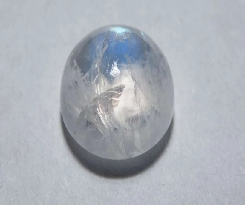 Moonstone for shifting: a smooth, milky moonstone with a soft blue flash