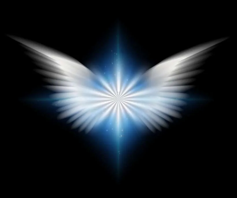 Common angel numbers and their meanings: glowing white angel wings around a burst of light